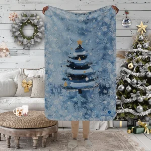 Manta con diseño de Árbol de Nieve pintado sobre fondo azul claro y copos