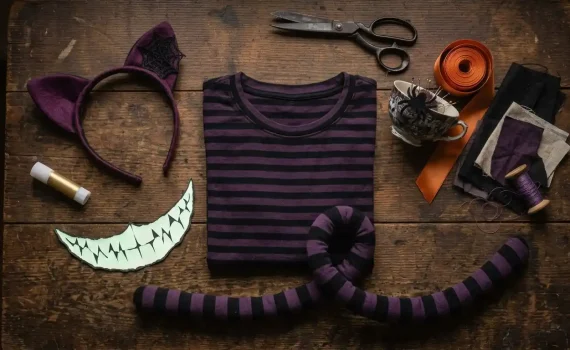 Diadema con orejas moradas y telaraña, camiseta de rayas moradas y negras, cola rayada y sonrisa de cartulina con dientes afilados para un disfraz de Gato de Cheshire de Halloween